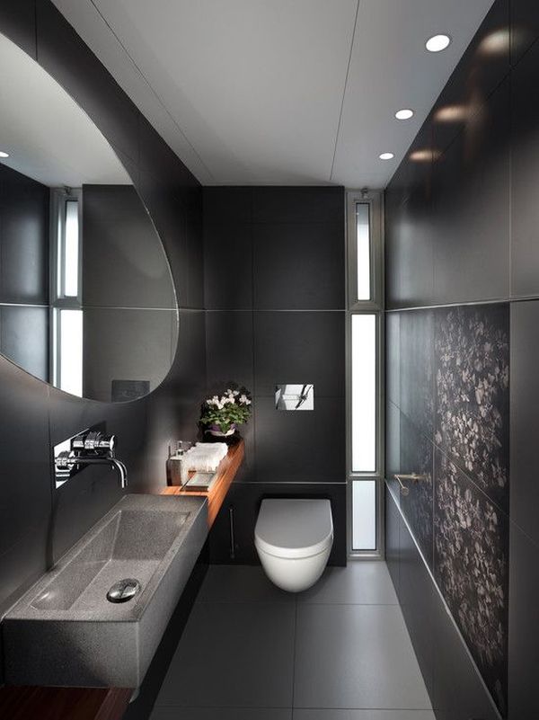 Banheiro pequeno com decoração escura