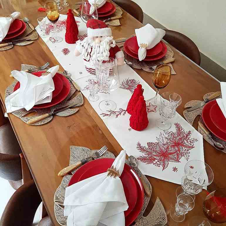 Mesa natalina com boneco de papai Noel e árvores